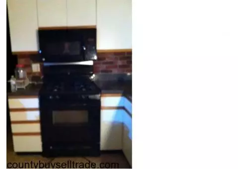 Kenmore stove. Microwave on top